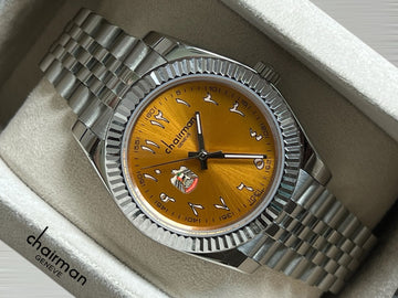 ABU DHABI Emblem Chairman Geneve Orange Arabic Dial Silver Chain Gents Watch